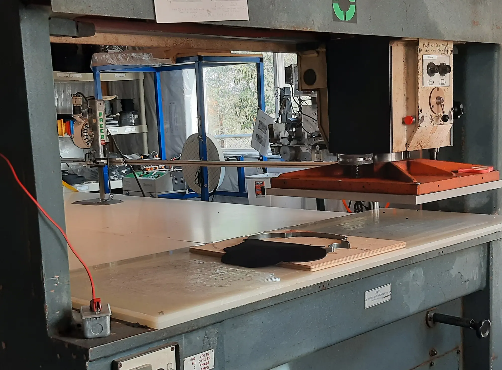 Industrial beam press used tp apply pressure to cutting die when cutting stacks of materials